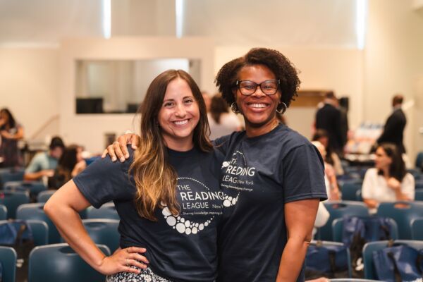 two women in TRL shirts at conference