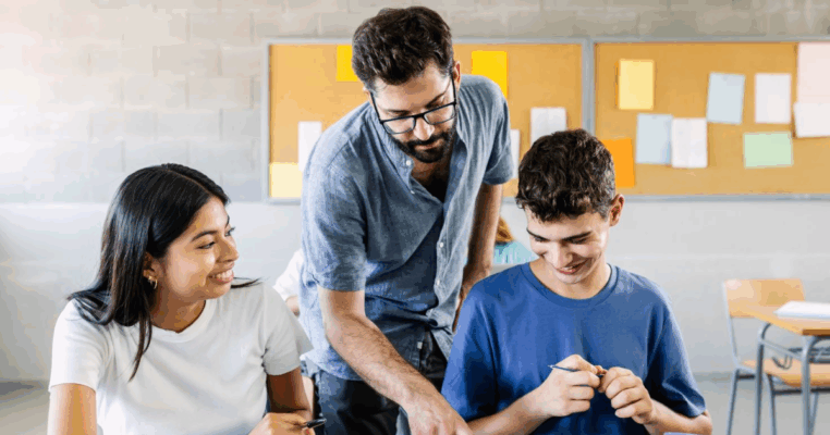 male teacher helping students