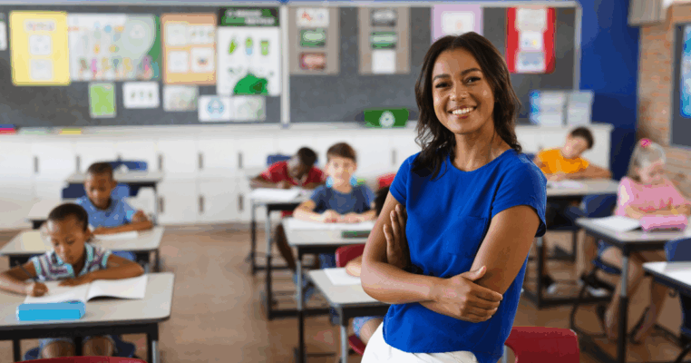 woman teacher smiling in front of class