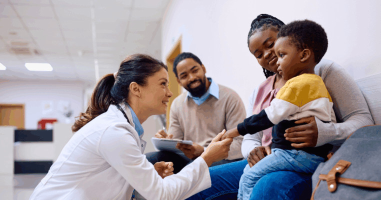 Pediatrician speaking with parents and young child
