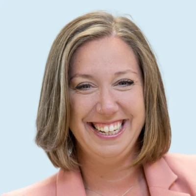 Becca Silver headshot with blue background