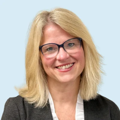 Beth Madden headshot with blue background