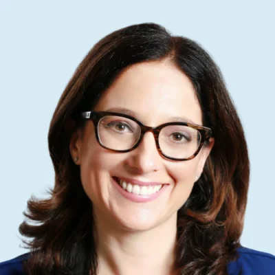 Carolyn Strom headshot with blue background