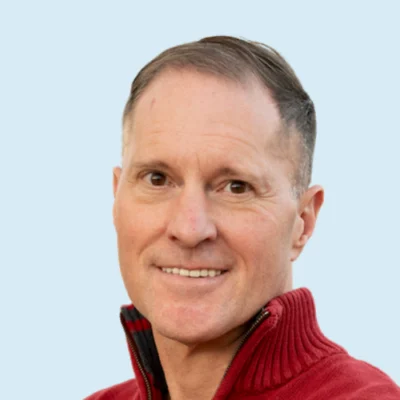 Chris Lemons headshot with blue background