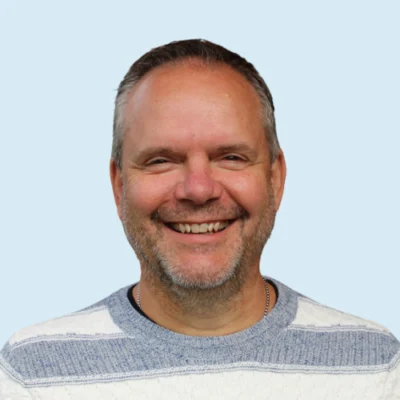 Daryl Michel headshot with blue background