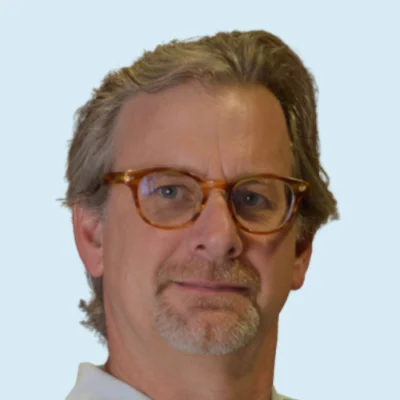 Don Compton headshot with blue background