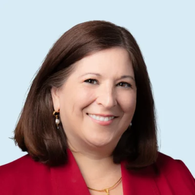 Elsa Cardenas Hagan headshot with blue background