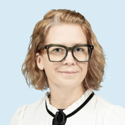 Genevieve Thomas headshot with blue background