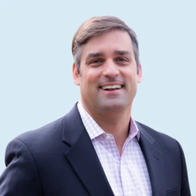 Grant Rivera headshot with blue background