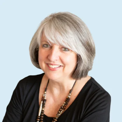 Holly Lane headshot with blue background