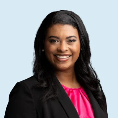 Jasmine Rogers headshot with blue background