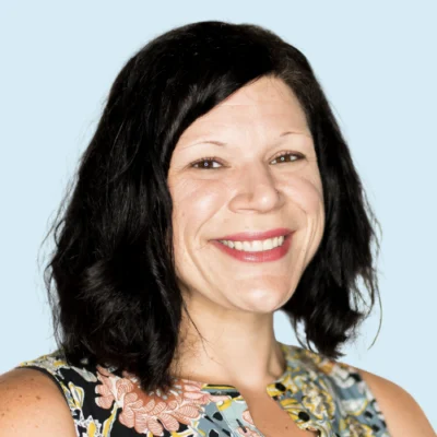 Jessica Toste headshot with blue background