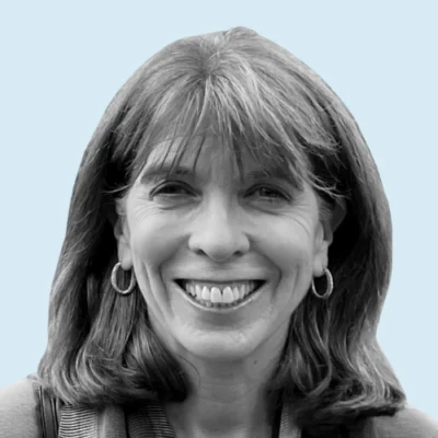 Joan Kelley headshot with blue background