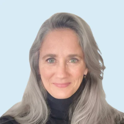 Julie Burtscher Brown headshot with blue background