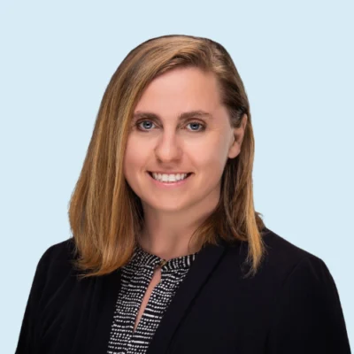 Kari Kurto headshot with blue background