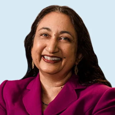 Kay Wijekmar headshot with blue background