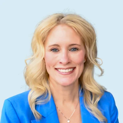 Kim St Martin headshot with blue background