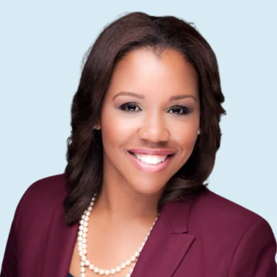 Kristen Wynn headshot with blue background