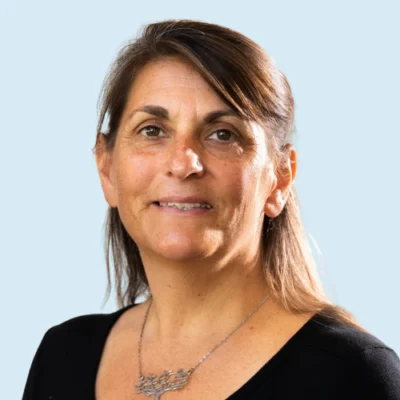 Lillian Duran headshot with blue background