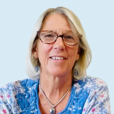 Margie Gillis headshot with blue background