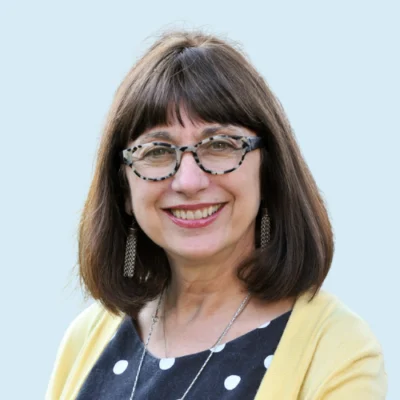Maryanne Wolf headshot with blue background