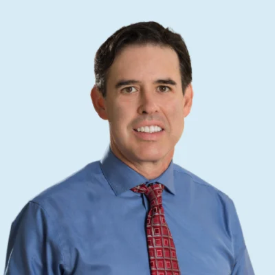 Michael Solis headshot with blue background