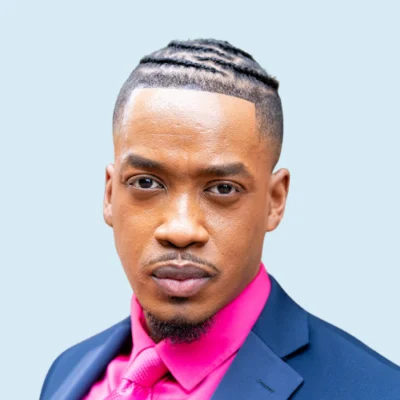 Mitchell Brookins headshot with blue background