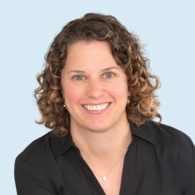 Molly Ness headshot with blue background