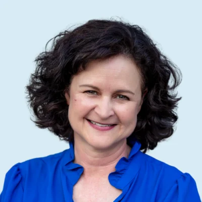 Stephanie Stollar headshot with blue background