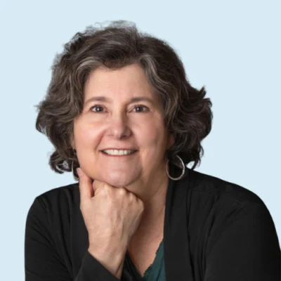 Sue Hegland headshot with blue background