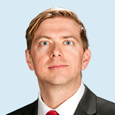 Tim Odegard headshot with blue background