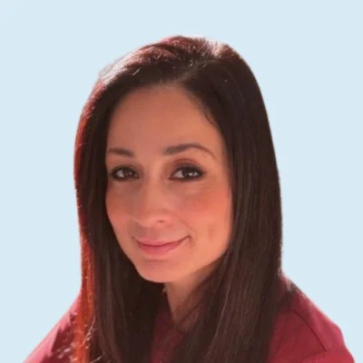 Tina Tom headshot with blue background