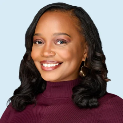 Yvette Manns headshot with blue background