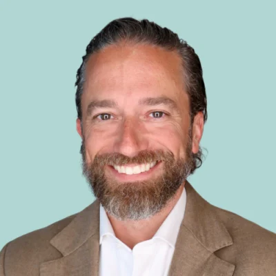 Adam Kronk headshot with green background