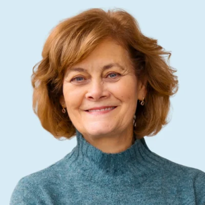 Carolyn Brown headshot with blue background