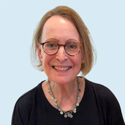 Nancy Eberhardt headshot with blue background
