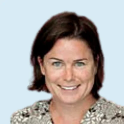 Cara McDermott-Fasy headshot with blue background