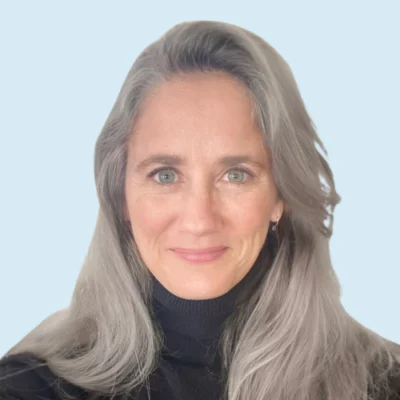 Julie Burtscher Brown headshot with blue background