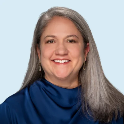 Marisa Ramirez Stukey headshot with blue background