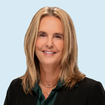 Pam Kastner headshot with blue background