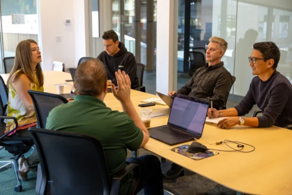 Jeff Knauss sitting at meeting table with team